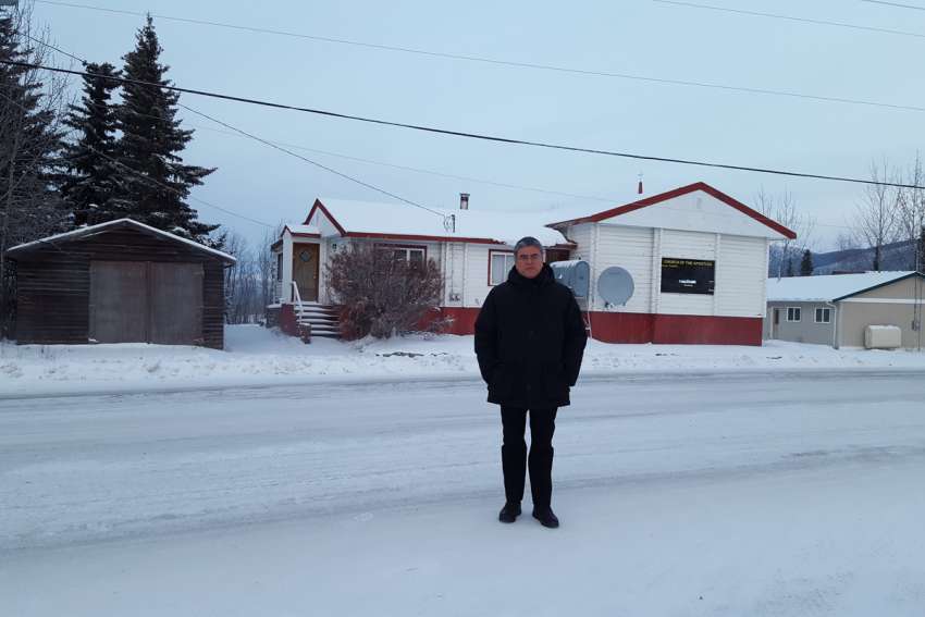 Bishop Héctor F. Vila standing outside of the Catholic Church of the Apostles in Faro, Yukon.