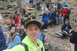 Leon Blais takes a selfie with a group of students on retreat, where he shared his personal conversion story.