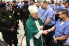 Archbishop Charles J. Chaput of Philadelphia greets inmates of Curran-Fromhold correctional facility in Philadelphia during a visit in mid-January. Pope Francis has a planned visit to the prison Sept. 27 during his two-day visit to the city. 