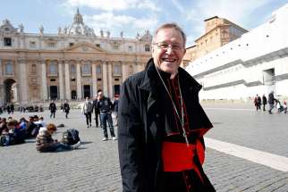 German Cardinal Walter Kasper walks smiles in St. Peters Square March 4.