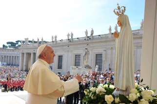 Pope Francis prays in front of a statue of Our Lady of Fatima at the Vatican May 13, 2015. The Pope will visit the Shrine of Our Lady of Fatima in Portugal May 12-13, 2017.