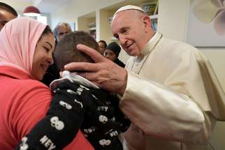  Pope Francis greets a child as he visits poor, sick people at a center run by the CasAmica Onlus organization on the outskirts of Rome Dec. 7. 