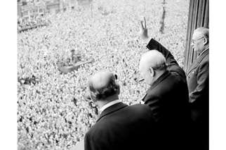 Winston Churchill waving to crowds in Whitehall on 8 May celebrating the end of the war.