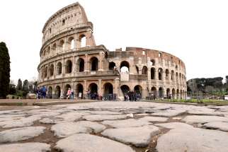 Very few people are seen in the area surrounding the Colosseum, which would usually be full of tourists, in Rome, March 2.