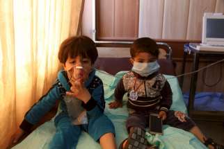 Children receive oxygen at a hospital in Taza, Iraq, March 9, after Islamic State militants fired mortar shells and rockets filled with &quot;poisonous substances&quot; into their village.