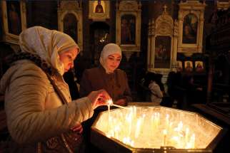 Christians light candles at Our Lady of Dormition Church in Damascus, Syria. Development and Peace wants the government to ensure a strong women’s voice for peace in war-torn areas like Syria. 