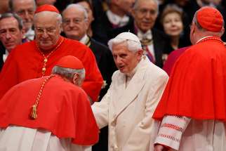 Retired Pope Benedict XVI greets cardinals before a consistory for the creation of new cardinals in St. Peter&#039;s Basilica at the Vatican in this Feb. 22, 2014, file photo. Pope Benedict has released an article addressing the roots of the clerical sexual abuse crisis in the Catholic Church and how the church should respond now. 