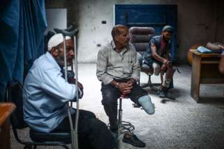 Syrian men who lost limbs during the civil war get prosthetic legs in Hamorya, Syria, in this Oct. 22, 2015, file photo.