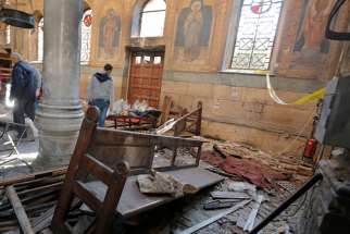 Egyptian security officials and investigators inspect the scene following a bombing inside Cairo&#039;s Coptic cathedral in Egypt December 11, 2016.