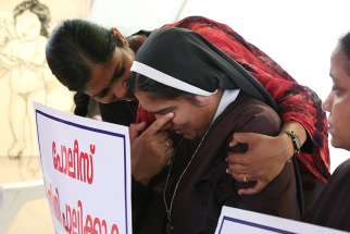 A woman religious is consoled during a Sept. 13 protest in Cochin, India, demanding justice after a nun accused Bishop Franco Bishop Franco Mulakkal of Jalandhar of raping her. 