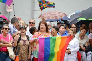 A crowd gathers for a massive same-sex wedding in San Juan, Puerto Rico, Aug. 16. Sixty-four of the 73 same-sex couples scheduled to take vows attended the event, the day a severe months-long drought broke with heavy rain throughout the island.