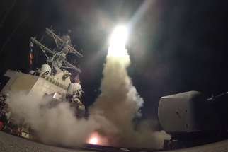 The USS Porter, in the Mediterranean Sea, fires a Tomahawk missile April 7. The missile strike on a Syrian air base days after chemical weapons were dropped on civilians in rebel-controlled territory further endangers innocent people, said observers familiar with the just-war theory.