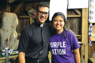 Camp counsellor Sophia Mutuc poses for a photo with priest and singer-songwriter Fr. Rob Galea.