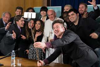Pope Francis poses for a selfie picture during a meeting of the Scholas Occurrentes at the Vatican May 29. The Scholas Occurrentes organization, which the pope also supported as archbishop of Buenos Aires, Argentina, promotes a &quot;culture of encounter&quot; through art, sports and technology. 