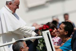 Pope Francis greets family members during his general audience in St. Peter&#039;s Square at the Vatican April 15.