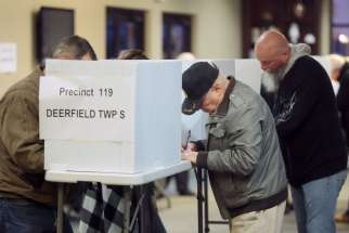 Voters cast their ballots during the presidential election Nov. 8 at a church in Deerfield Township, Ohio.
