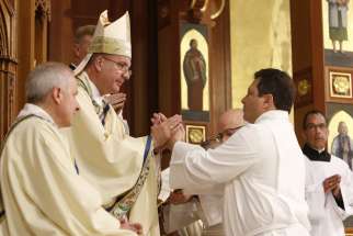 Ivan Toro makes his promise of obedience to Bishop John O. Barres of Rockville Centre, N.Y., during his ordination to the permanent diaconate June 1, 2019, at St. Agnes Cathedral in Rockville Centre.