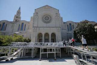 Workers assemble a stage Sept. 14 where Pope Francis will celebrate Mass outside the Basilica of the National Shrine of the Immaculate Conception in Washington Sept. 23.