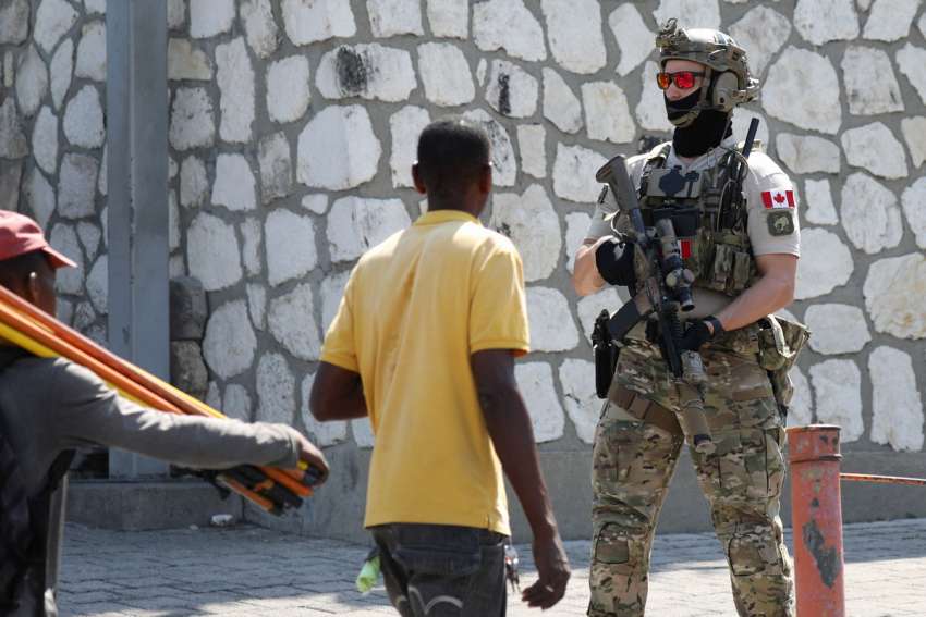 A Canadian soldier stands guard by the Canadian Embassy March 29, 2024, in Port-au-Prince, Haiti, as violence spreads and armed gangs expand their control over the capital.