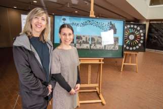 Art teacher Donna Sistilli, left, and English teacher Rita Sarra Macchios with some of the artwork that is part of the exhibition on Indigenous themes by adult students at Toronto’s Msgr. Fraser College. The teachers are part of the team in the Native Studies program at the school. 