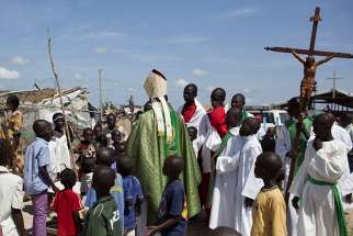 Cardinal Dieudonne Nzapalainga of Bangui, Central African Republic, greets youths after celebrating Mass for internally displaced people in Bangui in this 2015 file photo. Catholic bishops in the Central African Republic have distanced themselves from a group that is promising to defend the church and avenge the deaths of priests. 