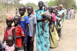 Residents displaced due to the recent fighting between government and rebel forces in Malakal, South Sudan, wait May 2 at a World Food Program outpost in Kuernyang Payam, where thousands have taken shelter.