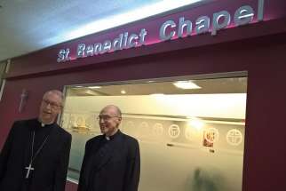 Edmonton Archbishop Richard Smith, left, and Fr. Oscar Monroy, chaplain of St. Benedict Chapel, outside the chapel housed at the City Centre Mall. As chaplain, Monroy has developed relationships with his neighbours in the stores that surround St. Benedict Chapel