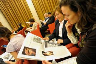 Women look at a new monthly women&#039;s insert called &quot;Women-Church-World&quot; in the Vatican&#039;s L&#039;Osservatore Romano newspaper this May 30, 2012, file photo. Pope Francis said he would look into New Testament deaconesses.