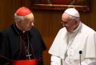 Pope Francis talks with Cardinal Lorenzo Baldisseri, general secretary of the Synod of Bishops on the family, before a session of the synod at the Vatican Oct. 9.
