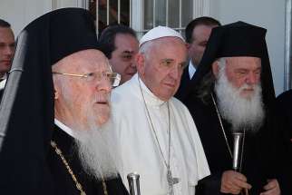 Pope Francis walks with Ecumenical Patriarch Bartholomew of Constantinople, left, and Orthodox Archbishop Ieronymos II of Athens and all of Greece, as they meet refugees at the Moria refugee camp on the island of Lesbos, Greece, April 16. Pope Francis will send high-level observers to the pan-Orthodox council meeting in Crete, beginning June 19, as a sign of respect, support and encouragement of the Orthodox Church.