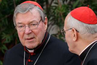 Australian Cardinal George Pell, prefect of the Vatican Secretariat for the Economy, talks with Cardinal Peter Erdo of Esztergom-Budapest, Hungary Oct. 14, 2014. Pell noted the Pope&#039;s Laudato Si&#039; encyclical had been &quot;well received&quot; but says the Church should be involved in scientific matters in an interview with Financial Times.