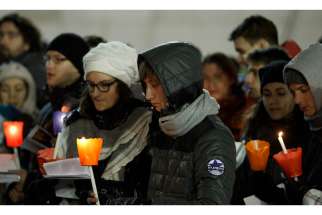 Young people hold candles as they participate in an ecumenical Taize prayer service St. Peter&#039;s Square at the Vatican Dec. 29, 2013.