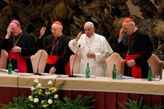 Pope Francis delivers his blessing during an event marking the 50th anniversary of the Synod of Bishops in Paul VI hall at the Vatican Oct. 17.