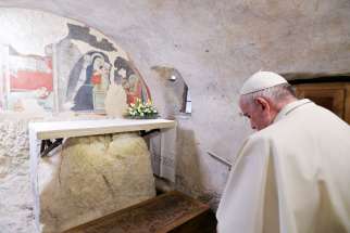 Pope Francis prays during a visit to the Nativity scene of Greccio, Italy, Dec. 1, 2019. The first Nativity scene was assembled in Greccio by St. Francis of Assisi in 1223.