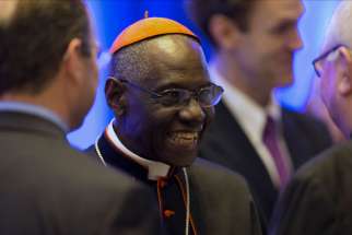 Guinean Cardinal Robert Sarah, prefect of the Congregation for Divine Worship, smiles as he talks with guests at the National Catholic Prayer Breakfast May 17 in Washington.