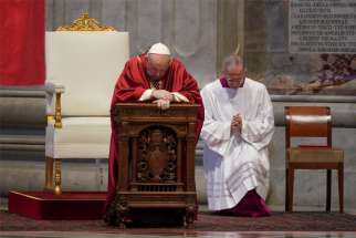 Pope Francis prays as he leads the Good Friday Liturgy of the Lord&#039;s Passion April 10, 2020, at the Altar of the Chair in St. Peter&#039;s Basilica at the Vatican.