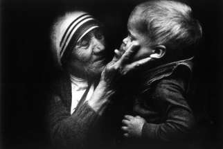 An undated file picture shows Blessed Teresa of Kolkata holding a child during a visit to Warsaw, Poland. Mother Teresa will be canonized by Pope Francis Sept. 4 at the Vatican.