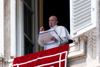 Pope Francis greets the crowd as he leads the Angelus from the window of his studio overlooking St. Peter&#039;s Square at the Vatican.