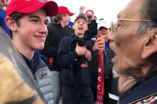 Nick Sandmann, a junior at Covington Catholic High School in Park Hills, Ky., and others students from the school stand in front of Native American Nathan Phillips near the Lincoln Memorial in Washington in this still image from video Jan. 18, 2019. The Washington Post settled a defamation lawsuit July 24, 2020, filed by his parents Ted and Julie Sandmann.