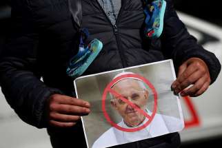  A protester holds a picture of Pope Francis during an Aug. 25 demonstration against clerical sex abuse in Dublin.