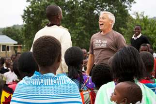 Greg Rogers welcomed by a Masai community in Kenya during a mission in 2014. 