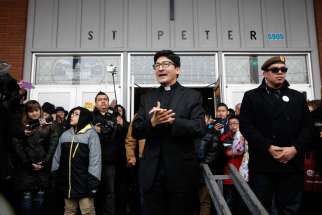 Father Raul Marquez of St. Peter Parish in Portland, Oregon, thanks people who came to stand vigil outside his church Feb. 5. The crowd formed a human shield a week after a group of eight men stood outside the front door of the church during a Spanish Mass and yelled insults about Catholicism, immigrants and the morals of the parish women.