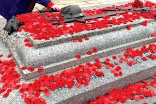 Poppies are laid on the tomb of the Unknown Soldier in Ottawa.