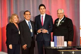 Truth and Reconciliation Commission commissioners Marie Wilson and Chief Wilton Littlechild, Prime Minister Justin Trudeau and TRC chair Justice Murray Sinclair Dec. 15 at the closing ceremony of the TRC. Trudeau was presented with a silver box containing a thumb drive of the final report.