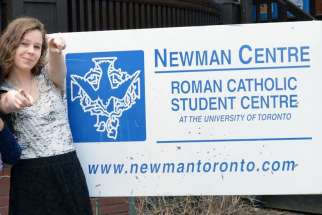 Kaylee Moynihan poses in front of her new residence at the Newman Centre on the University of Toronto downtown campus