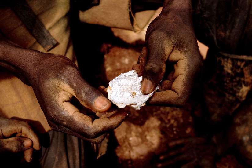 A mineworker in Chudja, Congo, shows a small piece of gold found after water processing in this June 2009 file photo. Congo’s Catholic bishops criticized the failure of Wester governments to stop the abuse of Congo’s natural resources.