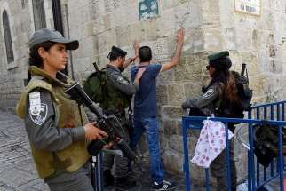 Israeli border police make a Palestinian face the wall for a body security check on the Via Dolorosa in Jerusalem&#039;s Old City Oct. 18, 2015. Following a mid-July shooting deaths of two Israeli policemen and three gunmen, tension has been running high in the Old City.