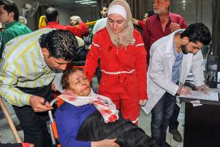 A wounded Syrian woman receives aid at a hospital April 7 in Damascus after a suspected chemical-weapon attack in Douma. Pope Francis condemned the use of chemical weapons after the deadly attack killed dozens of innocent men, women and children. 