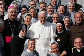 Pope Francis poses with clergy and women religious during his general audience in St. Peter&#039;s Square at the Vatican Oct. 7, 2015. The Pope has appointed a panel of six women and six men to study women deacons 