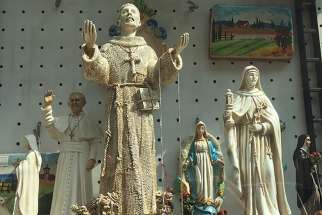 Statues of Pope Francis and his namesake, St. Francis, fill the windows of souvenir stores in Assisi.